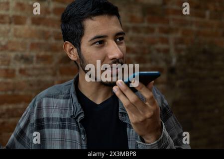 Latin American young man (24) talking on his cell phone. Concept of technology Stock Photo