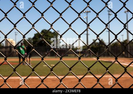 Focus on the fences with background Baseball field out of focus Stock Photo