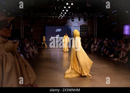 Istanbul, Turkey. 26th Apr, 2024. Models seen on a runaway for Buttonscarves. On the second day of the Istanbul Modest Fashion Week 2024, the Australian brand Akkoia, the Egyptian MRGD and the Indonesian Buttonscarves presented their collections in the final exclusive fashion show of Istanbul Modest Fashion Week 2024 in Fisekhane Gallery, Istanbul. Credit: SOPA Images Limited/Alamy Live News Stock Photo