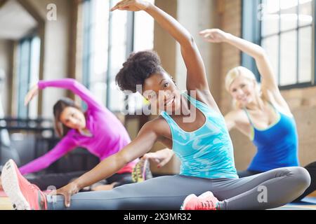 Black woman, portrait and instructor at yoga class, stretch and yogi for exercise on mat. Female person, trainer and confident for pilates or Stock Photo