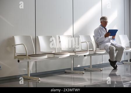 Doctor with tablet in waiting room, Onkologikoa Hospital, Oncology Institute, Case Center for prevention, diagnosis and treatment of cancer, Donostia, Stock Photo