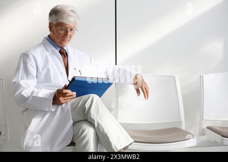Doctor with tablet in waiting room, Onkologikoa Hospital, Oncology Institute, Case Center for prevention, diagnosis and treatment of cancer, Donostia, Stock Photo