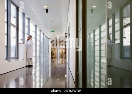 Doctor with tablet in corridor, Onkologikoa Hospital, Oncology Institute, Case Center for prevention, diagnosis and treatment of cancer, Donostia, San Stock Photo