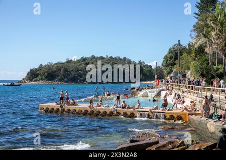 Fairy Bower ocean rockpool beside the scenic walkway between Manly Beach and Shelly beach,Sydney,NSW,Australia people swim on hot autumn day Stock Photo