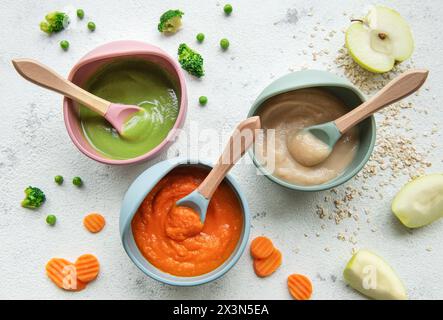 Healthy baby food in bowls.  Various bowls of fruit and vegetable puree, top view Stock Photo