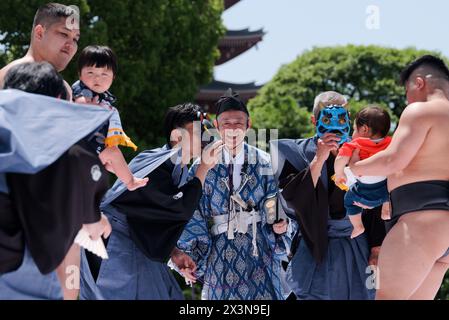 Tokyo, Japan. 28th Apr, 2024. Sumo wrestlers hold children during the Naki Sumo Crying Baby Contest in Tokyo, Japan, on April 28, 2024. Naki Sumo is a traditional ceremony performed as a prayer for healthy growth. Credit: Zhang Xiaoyu/Xinhua/Alamy Live News Stock Photo