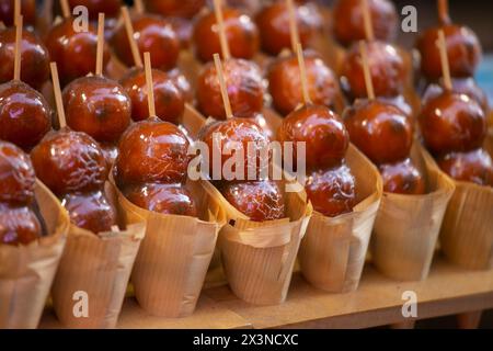 Mitarashi Dango (Japanese Rice Dumplings with Sweet Soy Glaze) in a street food stall in Osaka, Japan. Stock Photo