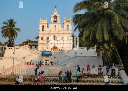 Panaji, India - February 3, 2024: People walking in front of the Our Lady of the Immaculate Conception Church in Panaji, Goa, India. Stock Photo