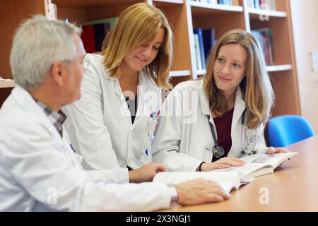 Doctor teaching medical students in library, Doctors in meeting room, Hospital Donostia, San Sebastian, Gipuzkoa, Basque Country, Spain Stock Photo