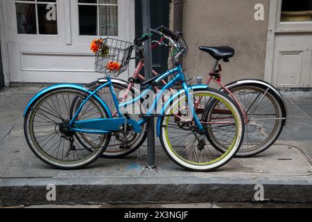 French Quarter, New Orleans, Louisiana.  Two Bicycles Locked to a Pole on Royal Street. Stock Photo