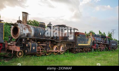 The partly dismantled, rusting remains of vintage steam engines lined up in a siding at Trinidad Railway Station, Trinidad, Cuba. Stock Photo