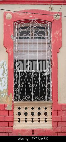Metal grilles over windows of older houses in the backstreets of Trinidad, Cuba. Stock Photo