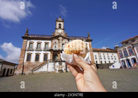 Pao de queijo (Brazilian cheese bun) in Tiradentes Square, Ouro Preto, Minas Gerais, Brazil, the city is World Heritage Site by UNESCO Stock Photo