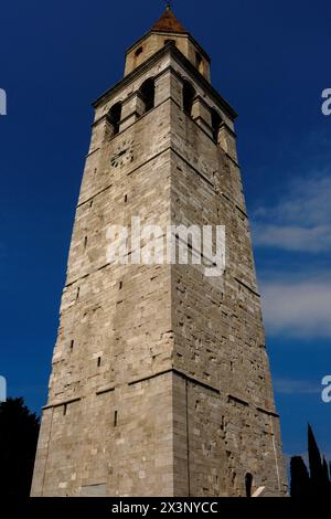 Romanesque bell tower of the Basilica of Santa Maria Assunta in Aquileia, Udine province, Friuli Venezia Giulia, Italy.  The tower was added to the Basilica in 1031 and completed in the 1200s.  The top of the tower was remodelled in the 1460s. Stock Photo