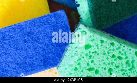 Colorful Cleaning Aids. A stack of blue, green, and yellow sponges. Uses for Cleaning product catalogs, household guides. Stock Photo