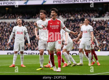 Tottenham Hotspur's Pierre-Emile Hojbjerg (second left) reacts after scoring an own goal giving Arsenal their first of the game, as Arsenal's Takehiro Tomiyasu celebrates during the Premier League match at the Tottenham Hotspur Stadium, London. Picture date: Sunday April 28, 2024. Stock Photo