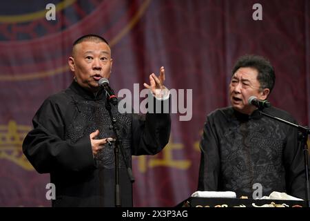(240428) -- LONDON, April 28, 2024 (Xinhua) -- Guo Degang (L) and Yu Qian perform Xiangsheng, or crosstalk comedy in London, Britain, April 27, 2024.  Thunderous laughter and applause almost blew off the roof of an auditorium in London's ExCeL Exhibition Centre on Saturday night, when a punchline by Guo Degang, a popular Chinese traditional crosstalk comedian, landed with an audience of thousands.   Along with Guo and his partner Yu Qian, a handful of comedians from the De Yun She Performance Group performed Xiangsheng, or crosstalk comedy, with both jokes about life anecdotes and traditional Stock Photo
