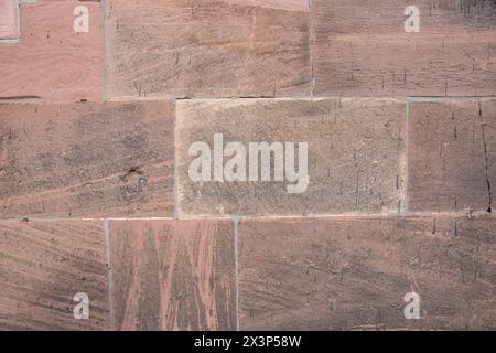 Structural stone wall of the ancient building consists of red big old bricks. Nature structural background. Stock Photo