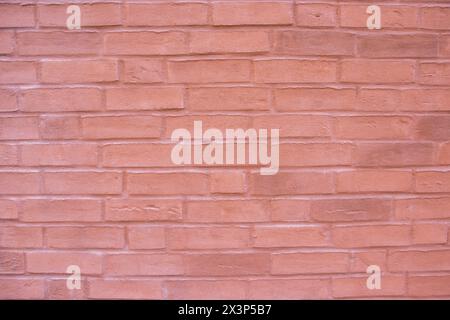 Structural stone wall of the modern building consists of red little bricks. Nature structural background. Stock Photo