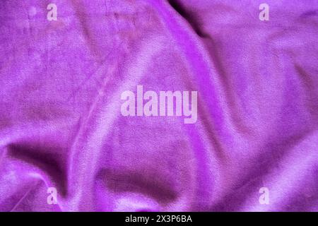 Lilac knitted texture fabric. Purple textile cloth background. Soft material for fashion clothes. Stock Photo