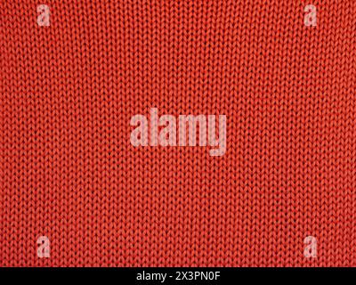 Closeup of orange knitted fabric with large stitches Stock Photo