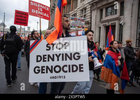 London, UK. 27th Apr, 2024. Protesters march with flags and placards towards the Whitehall in London, UK during the demonstration. The 109th anniversary of the Armenian genocide was commemorated on the April 24th, 2024. And is considered the beginning of the genocide when the Turkish army deported and executed many intellectuals. And an estimate of 1.5 million people were killed. Nowadays, the Turkish government still denys the massacre. Though many countries recognized this first world war act as genocide. Credit: SOPA Images Limited/Alamy Live News Stock Photo