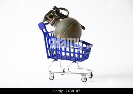 A hand grenade lies in a shopping cart on a white background, gun trade, gun store and business Stock Photo