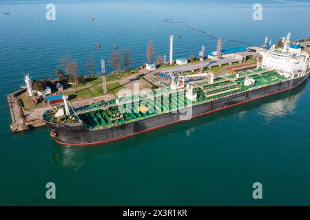 Aerial view of ship tanker vessel loading in gas and oil terminal station refinery, Global trading import export logistic transport sea freight cargo Stock Photo