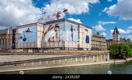 Large Yves Saint Laurent advertising billboards covering the scaffoldings of the restoration works of a building along the river Seine, Paris, France Stock Photo
