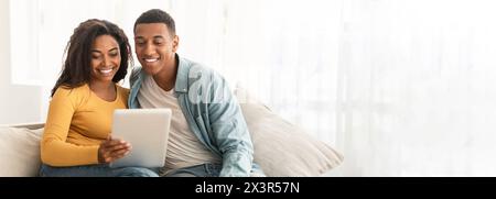 Couple with tablet enjoying time together at home Stock Photo