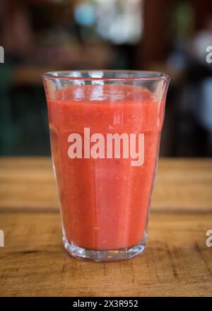 Homemade fresh strawberry smoothie in a glass on a wooden table in a café restaurant Stock Photo
