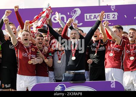 27/04/2024, Ochilview Park, Stenhousemuir, Scotland, United Kingdom, Manager Gary Naismith celebrates with his players and coaching staff as Stenhousemuir FC lift the Cinch Scottish League Two trophy, the clubs first title in its 140 year history. Credit: Thomas Gorman/Alamy Live News Stock Photo