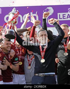 27/04/2024, Ochilview Park, Stenhousemuir, Scotland, United Kingdom, Manager Gary Naismith celebrates with his players and coaching staff as Stenhousemuir FC lift the Cinch Scottish League Two trophy, the clubs first title in its 140 year history. Credit: Thomas Gorman/Alamy Live News Stock Photo