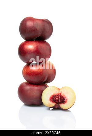 four peaches stacked nectarines and sliced plum fruit isolated on white background. clipping path included. Stock Photo