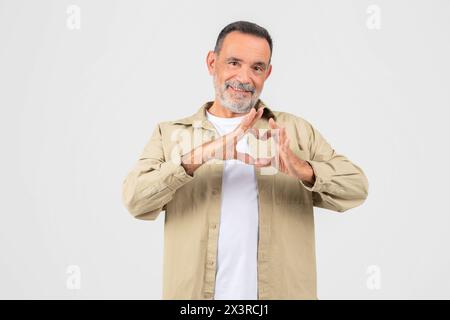 Man Making Heart Shape With Hands On White Stock Photo