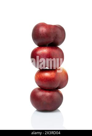 four peaches stacked nectarines plum fruit isolated on white background. clipping path included. Stock Photo