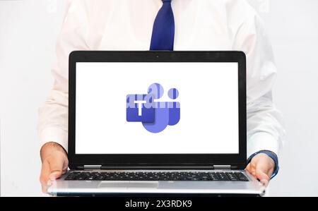 Microsoft team is used to manage people within organization to have a track record, editorial background person showing on laptop Stock Photo