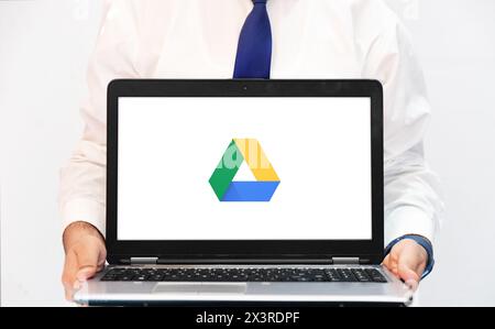 Person Showing Google Drive on Laptop Screen, editorial background. Storage providing service editorial backdrop Stock Photo