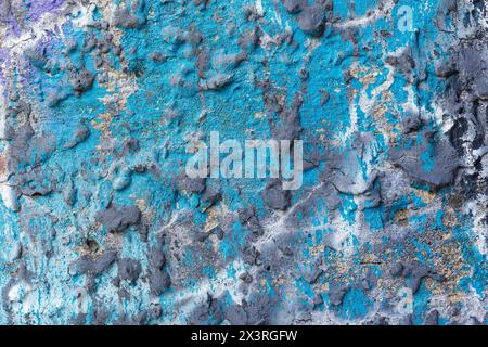 Cyan blue wrinkled old concrete wall splashed with gray paint. Stock Photo