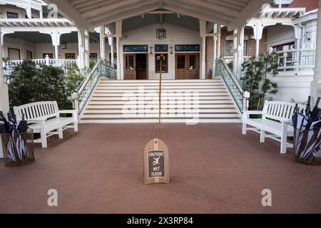 San Diego, CA. April 5, 2024. Front entrance of Hotel del Coronado with a “wet floor” sign. Built in 1888, this hotel is a historical tourist attracti Stock Photo