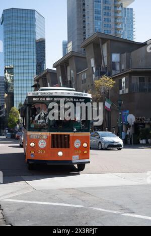 San Diego, CA. April 6, 2024. San Diego Trolley in little italy, an orange color tourist tram  that stop at turist spots Stock Photo