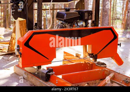 Process of machining logs in equipment sawmill machine saw saws tree trunk on plank boards Stock Photo