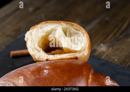 such a bun in jam on the table, a half-broken bun for tea Stock Photo