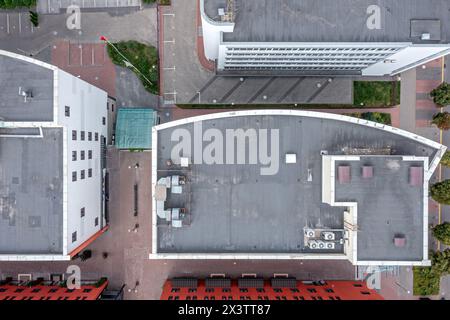 industrial commerce office building with ventilation system and air conditioner fans on roof. aerial overhead view. Stock Photo