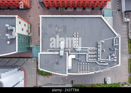 roof of a small office building with efficient ventilation system and air conditioning equipment. aerial top view. Stock Photo