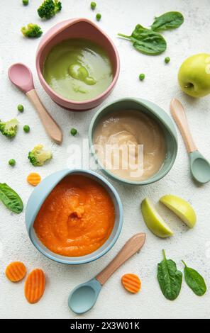 Healthy baby food in bowls.  Various bowls of fruit and vegetable puree, top view Stock Photo