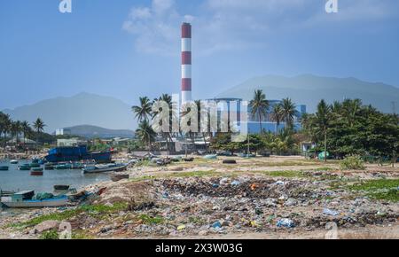 Spilled garbage on beach of big city. Empty used dirty plastic bottles. Dirty sea sandy shore. Environmental pollution. Ecological problem. Save plane Stock Photo