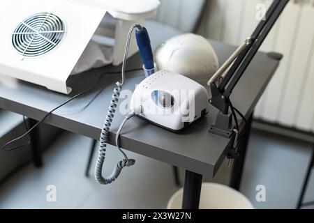 Electric manicure machine on table. Drill for manicure Stock Photo