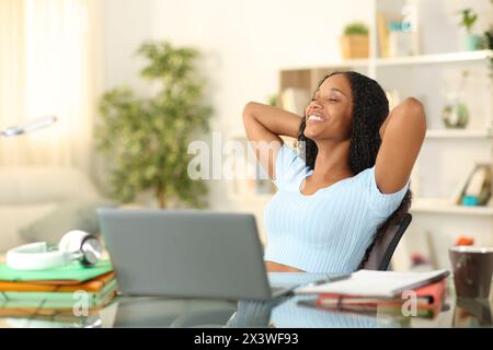 Happy student relaxing sitting at home Stock Photo