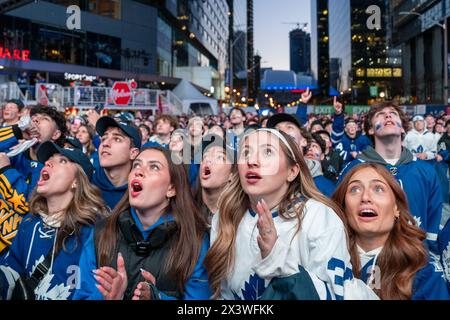 April 24, 2024, Toronto, Ontario, Canada: Fans gather at Maple Leaf Square outside Scotibank Arena, watching Round 1, Game 4 playoff game of Toronto Maple Leafs vs Boston Bruins playoff game on a giant screen. During Toronto Maple Leafs playoff games, Maple Leaf Square transforms into a sea of blue and white, echoing with the chants of passionate fans eagerly rallying behind their team's quest for victory. The electric atmosphere radiates anticipation and excitement, creating unforgettable memories for both die-hard supporters and casual observers alike. (Credit Image: © Shawn Goldberg/SOPA Im Stock Photo